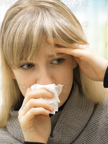 Young woman using a tissue