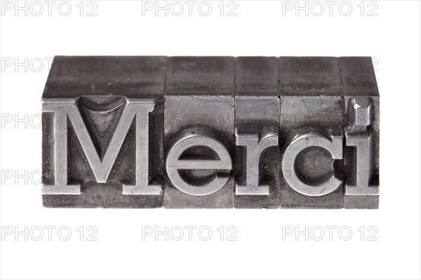 Old lead letters forming the word 'Merci'