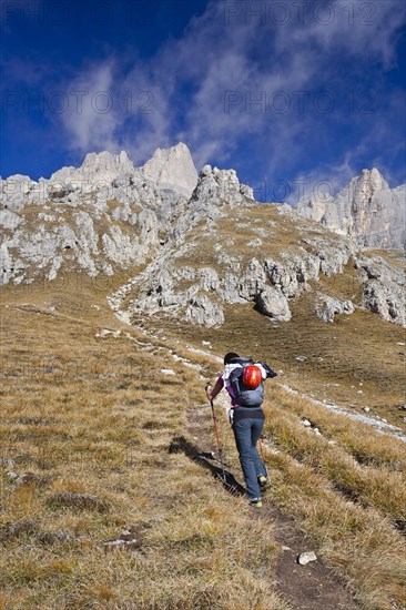 Hiker climbing Piz Boe mountain