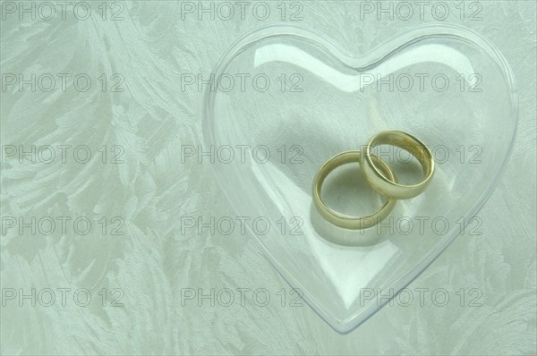 Wedding rings in a transparent heart