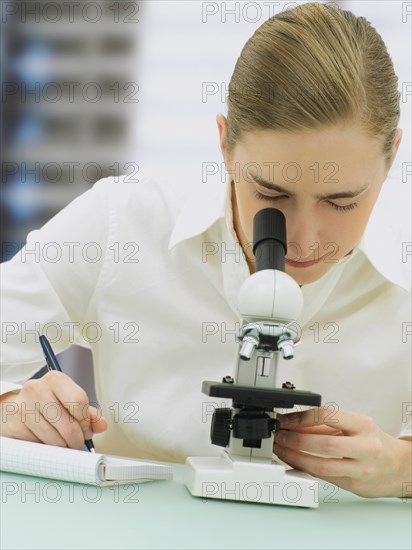 Scientist looking through a microscope