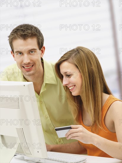 Young couple shopping online with a computer