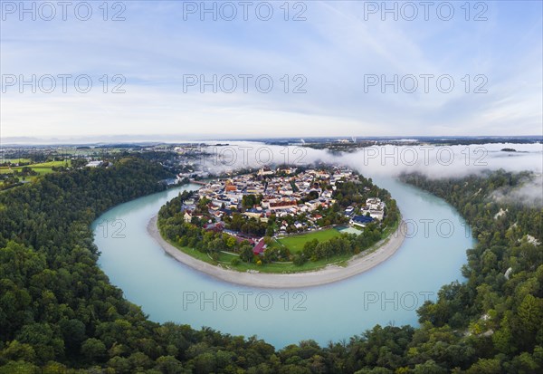 Old town in river bend of the Inn with fog