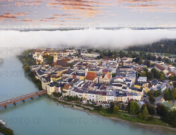 Old town in river loop of the Inn at dawn and fog