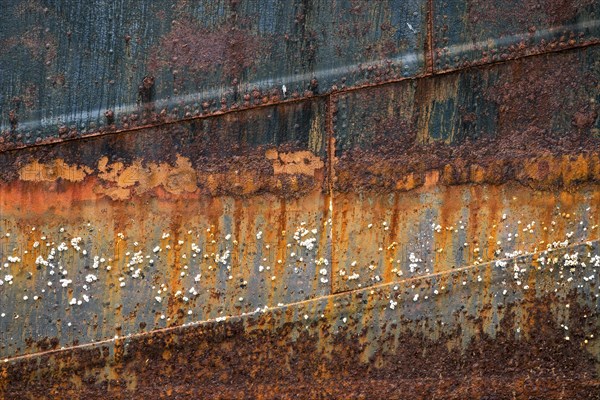 Rusty hull with barnacles