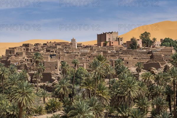Overlook over the oasis of Taghit with sand dunes