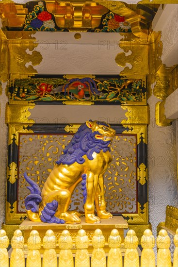 Guardian statue at the golden decorated Yomeimon Gate