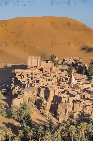 Overlook over the oasis of Taghit with sand dunes