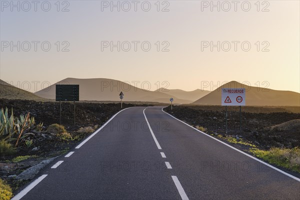 Country road through lava field in evening light