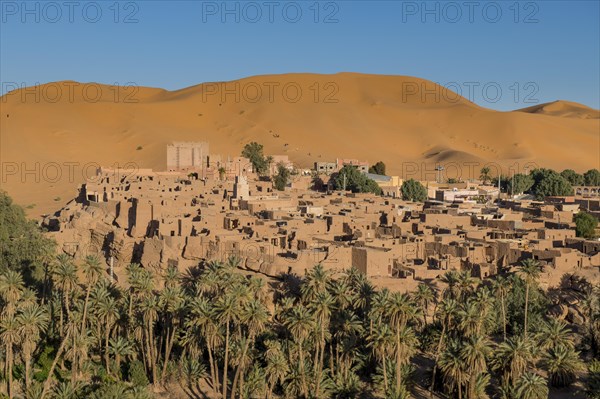 Overlook over the oasis of Taghit with sand dunes