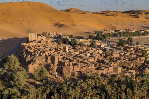 Overlook over the oasis of Taghit with sand dunes