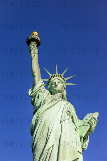 Statue of Liberty in front of blue sky