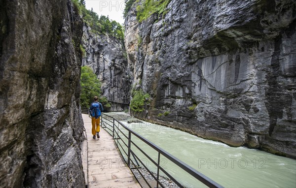 Young man hiking in the Aare gorge in the Haslital