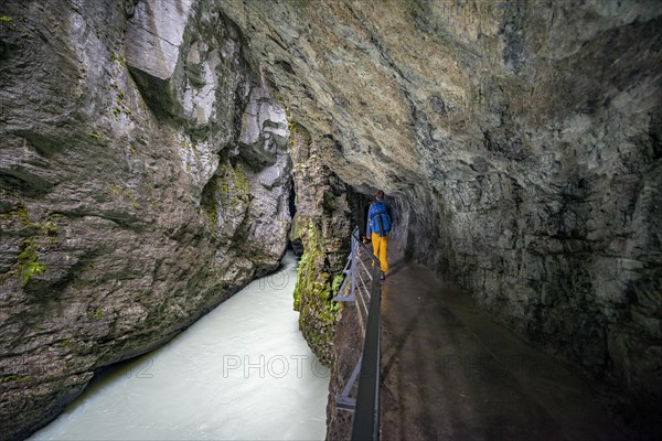 Young man hiking in the Aare gorge in the Haslital