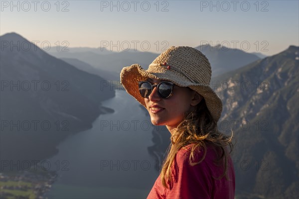 Young woman with sunglasses and sun hat