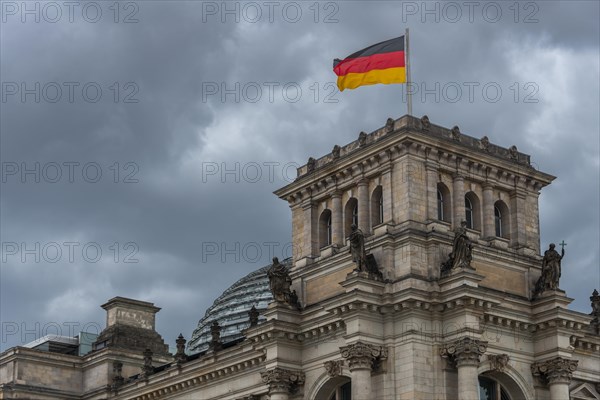 Reichstag with waving German flag at the Spree