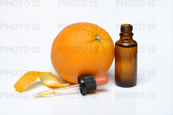 Orange and orange oil in bottle with pipette