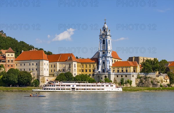 Excursion boat on the Danube in front of the baroque church of the monastery Duernstein
