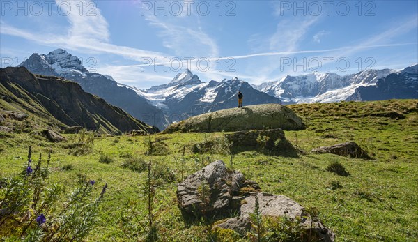 Hiker stands on a large rock