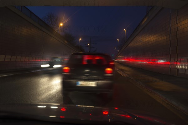 Driving cars at night in the tunnel exit