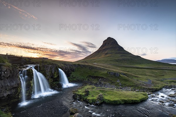 Waterfall Kirkjufellsfoss and mountain Kirkjufell at sunset