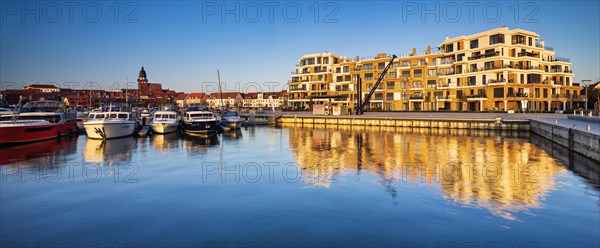 City harbour with modern hotel complex in the evening light