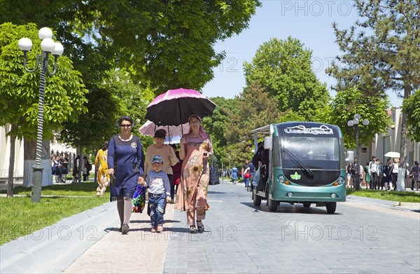 Walker with parasol and golf card on Tashkent Street