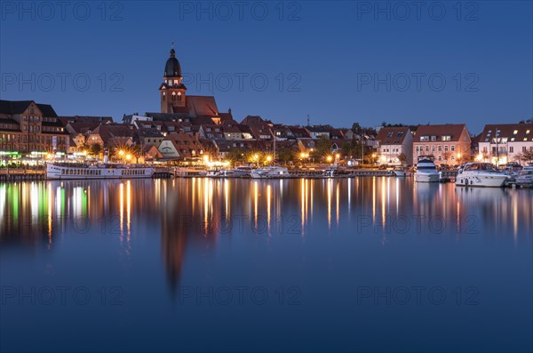 City harbour with church St. Marien at dusk