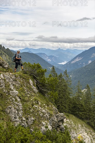Hiker looks at the Sylvenstein Dam