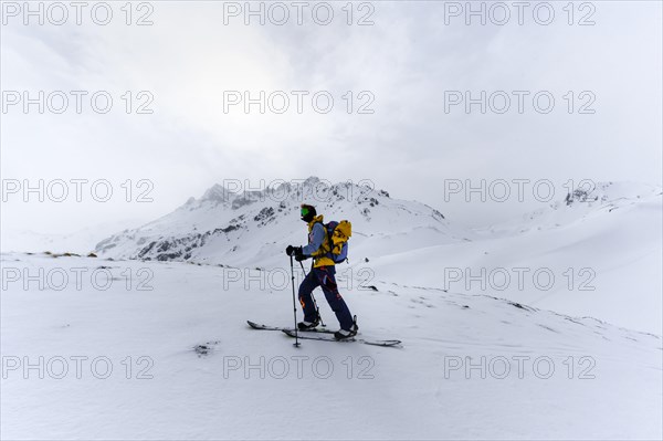 Ski tourers in the snow in fog