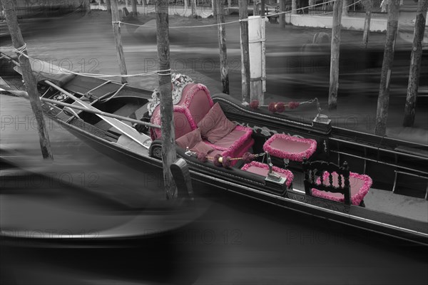 Gondola with fading red seat cushions