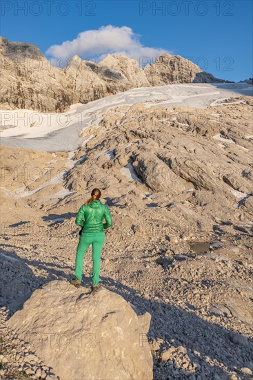 Hiker looks at alpine landscape
