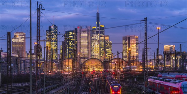 Train and tracks in front of main station and skyline Frankfurt Main in the evening