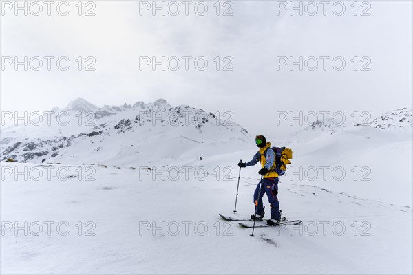 Ski tourers in the snow in fog
