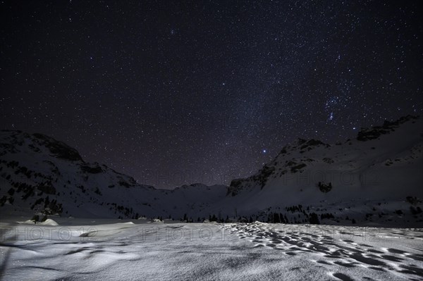 Starry sky with milky way in the mountains in winter
