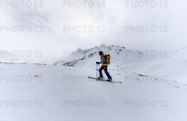 Ski tourers in the snow in fog