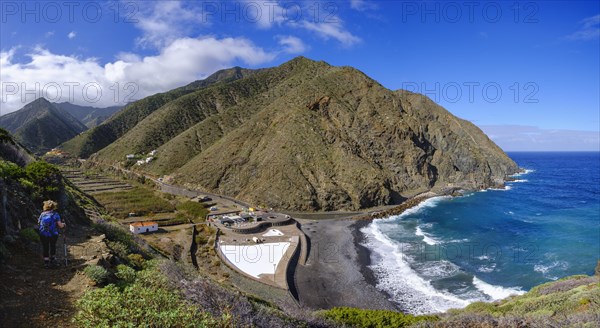 Woman hiking on hiking trail via Playa del Vallehermoso