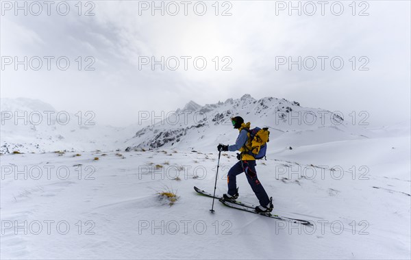 Ski tourers in the snow in fog