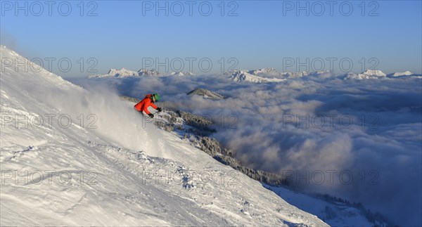 Female skier descending steep slope