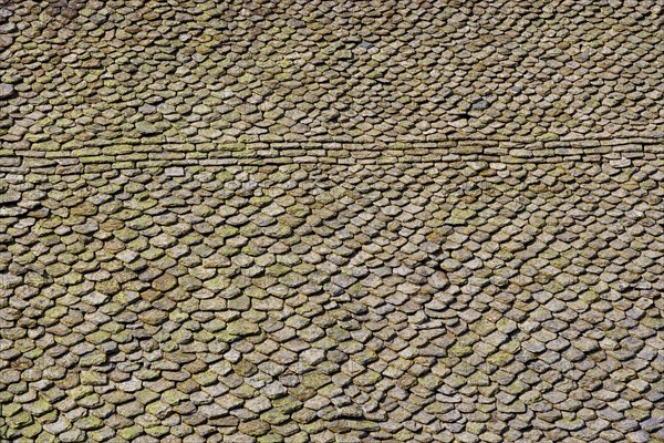 Church roof covered with stone tiles