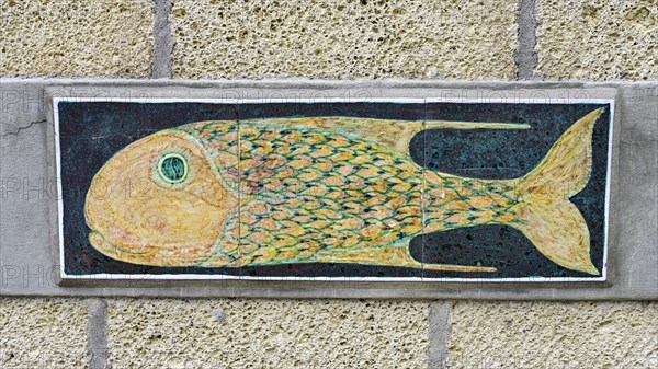 Pottery with fish motif on a house wall