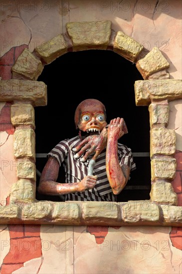Horror figure in window on ghost train at the Wiesn