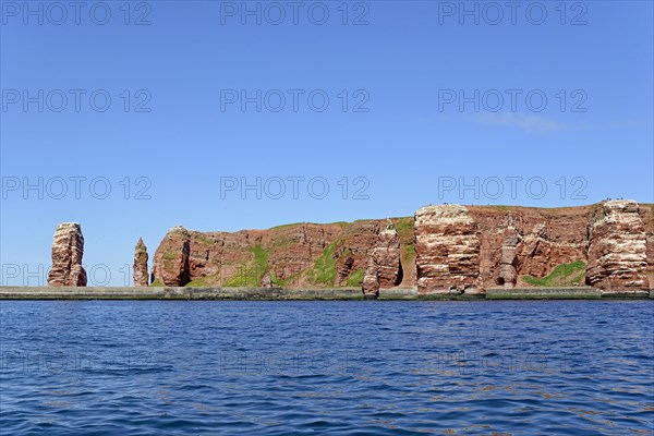 View from the water to the red sandstone rocks with Langer Anna