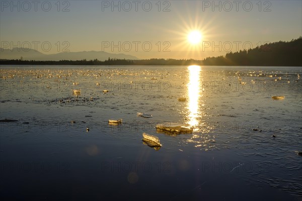 Small ice floes on frozen lake in winter