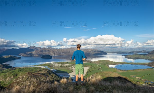 Hiker is looking out for Wanaka Lake and mountains, Rocky Peak