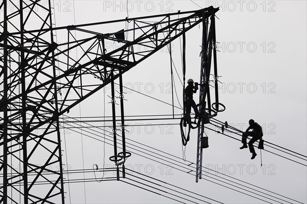 High voltage engineers working on high voltage pylons, Baden-Wuerttemberg