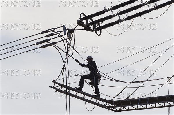 High-voltage engineer working on high-voltage line, Baden-Wuerttemberg