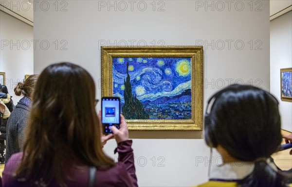 Visitors in front of the painting Starry Night by Vincent van Gogh