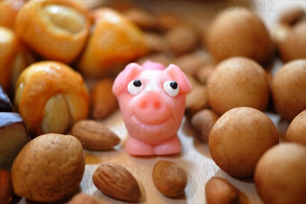 Pink marzipan pig with almonds