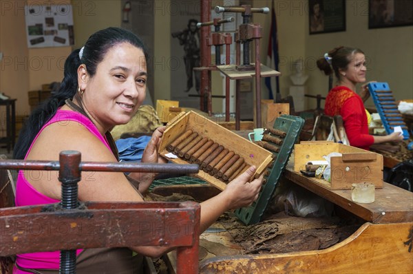 Worker shows cigars